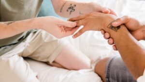 Couple exchanging rings during intimate home wedding ceremony