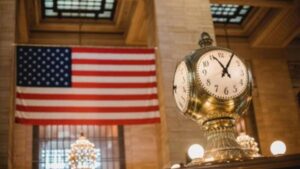 American flag and vintage clock inside historic government building interior.