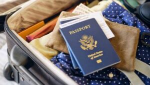 U.S. passport in open suitcase packed for international travel.